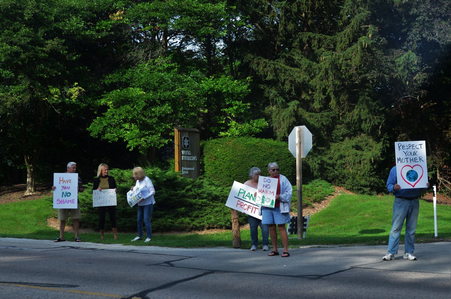 Protestors hold signs
